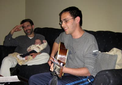 Jona plays the guitar for his family.