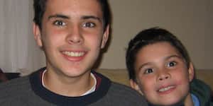 Jona and his brother holding soccer balls.